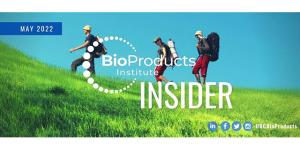 Hikers on grassy hill BioProducts Insider